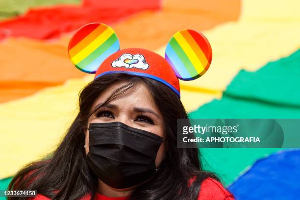 Woman wears Mickey Mouse ears with the Pride colors during a LGBT community Pride parade on June 26, 2021 in San Salvador, El Salvador. The parade...