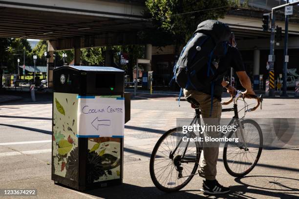 Sign directs residents to a public cooling shelter set up during a heatwave in Portland, Oregon, U.S., on Saturday, June 26, 2021. Record heat is set...