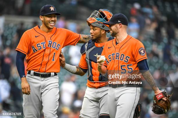 From left, Carlos Correa, Martin Maldonado and Ryan Pressly of the Houston Astros celebrate their win against the Detroit Tigers in game two of a...