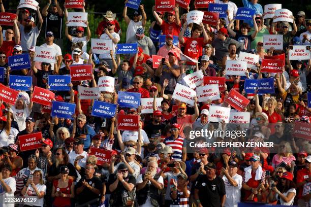Trump supporters hold "Save America" signs as they wait to see former President Donald Trump speak during a campaign-style rally in Wellington, Ohio,...