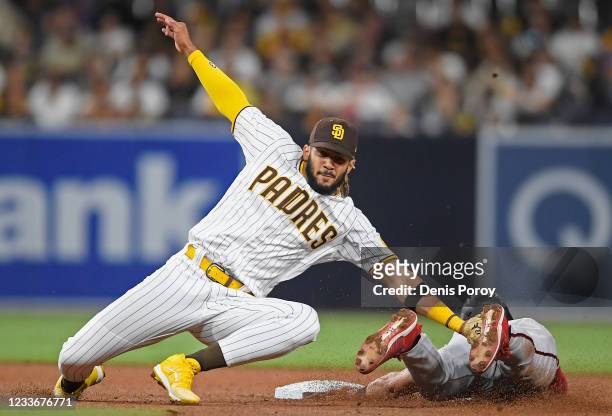 Fernando Tatis Jr. #23 of the San Diego Padres tags Josh Rojas of the Arizona Diamondbacks out as he tries to steal second base during the fourth...