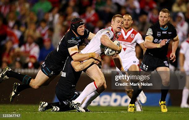 Nolan Stringer Ben Creagh of the Dragons is atckled during the round 26 NRL match ...