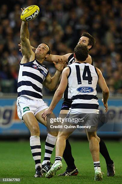 Brad Ottens of the Cats competes in the ruck against Darren Jolly of the Magpies during the round 24 AFL match between the Collingwood Magpies and...