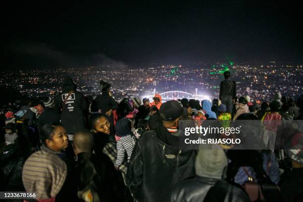 Residents of Antananarivo attend the festivities taking place at the brand new Barea stadium from the hill of Andohalo during the celebration of the...