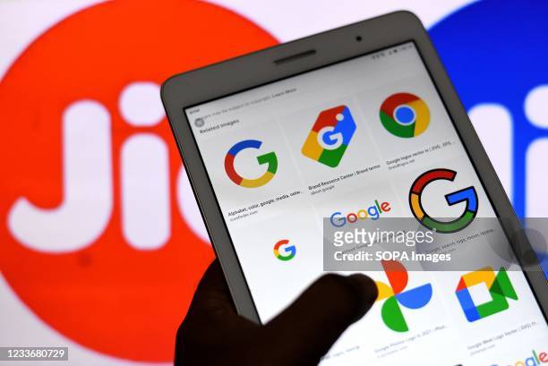In this Photo illustration Google logos seen displayed on an Android phone with a Reliance Jio logo in the background.