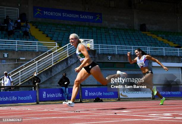Dublin , Ireland - 27 June 2021; Sarah Lavin of Emerald AC, Limerick, left, dips for the line to win the Women's 100m Hurdles ahead of Kate Doherty...