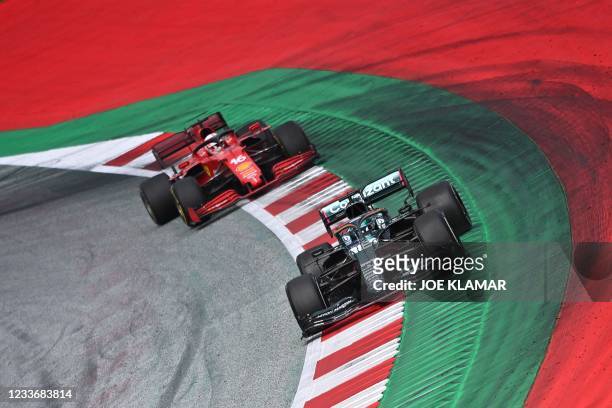 Aston Martin's Canadian driver Lance Stroll competes with Ferrari's Monegasque driver Charles Leclerc during the Formula One Styrian Grand Prix at...