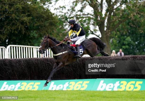 Storm Home ridden by Brendan Powell clears a hurdle on their way to winning the bet365 Summer Cup at Uttoxeter Racecourse on June 27, 2021 in...