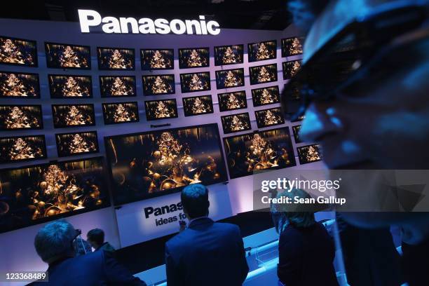 Visitors wear 3D glasses while watching a presentation of 3D televisions at the Panasonic stand at the IFA 2011 consumer electonics and appliances...