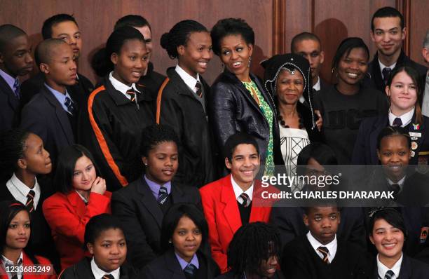 First lady Michelle Obama stands with Mamphela Ramphele , and high school students after she answered students' questions at the University of Cape...