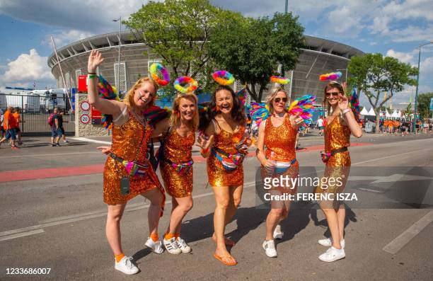 Dutch women football fans wearing rainbow rings and wings pose outside the Puskas Arena prior the UEFA EURO 2020 football match between Netherlands...