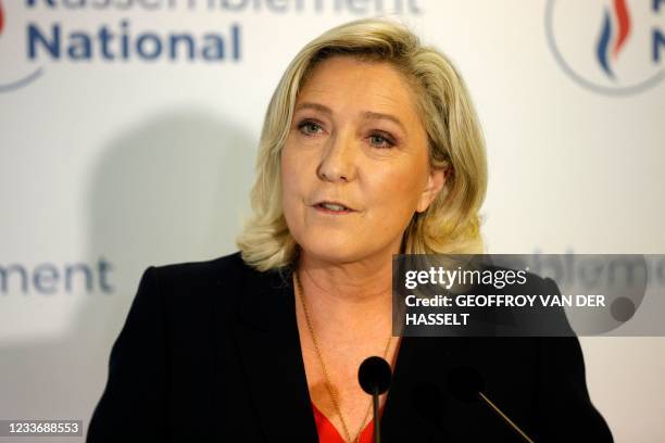 French far-right Rassemblement National party's leader and member of parliament Marine Le Pen speaks to the press at the party's headquarters after...