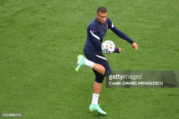 France's forward Kylian Mbappe takes part in their MD-1 training session at the National Arena in Bucharest on June 27 on the eve of their UEFA EURO...