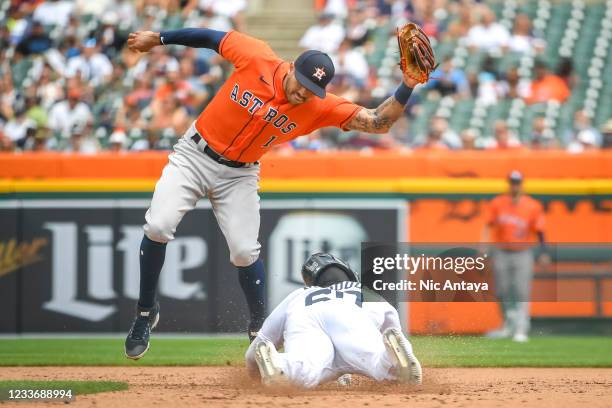 Akil Baddoo of the Detroit Tigers steals second base against Carlos Correa of the Houston Astros during the bottom of the sixth inning at Comerica...