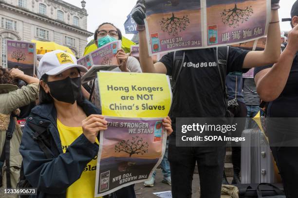 Protester holds a placard that says Hong Kongers are NOT China's Slaves during the demonstration. Following the close down of pro democracy newspaper...