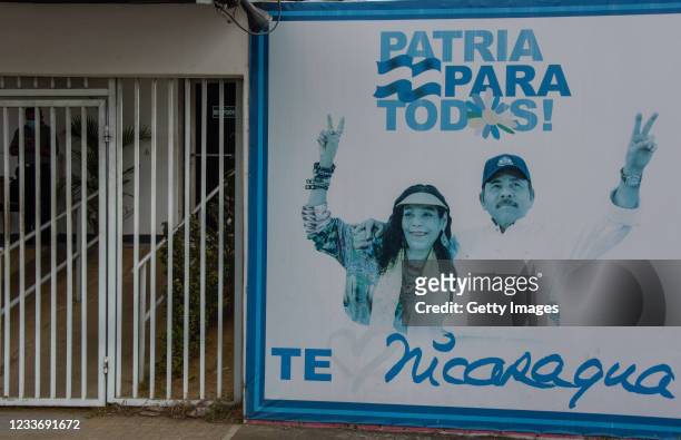 View of a billboard with the picture of Nicaraguan President Daniel Ortega and Vice-President Rosario Murillo at the entrance of a government office...