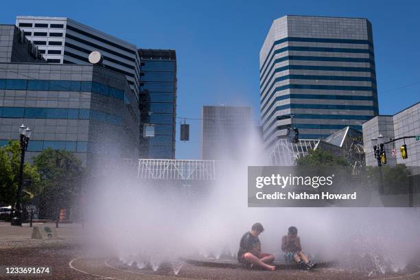 Kids play in the Salmon Springs Fountain on June 27, 2021 in Portland, Oregon. Record breaking temperatures lingered over the Northwest during a...