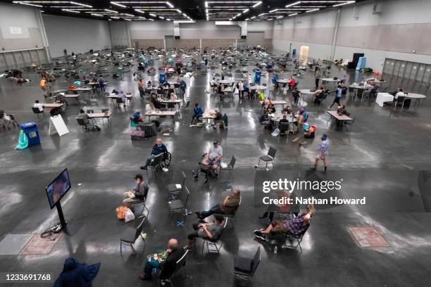 Portland residents fill a cooling center with a capacity of about 300 people at the Oregon Convention Center June 27, 2021 in Portland, Oregon....