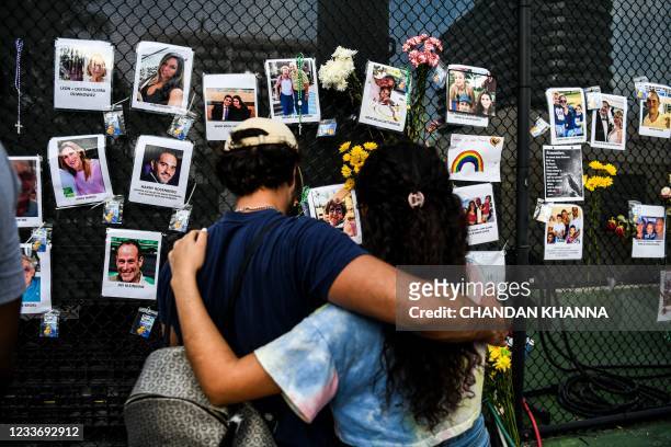 People visit the makeshift memorial for the victims of the building collapse, near the site of the accident in Surfside, Florida, north of Miami...