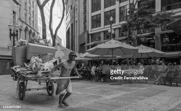 man pulling a cart in sao paulo downtown - unfairness stock pictures, royalty-free photos & images