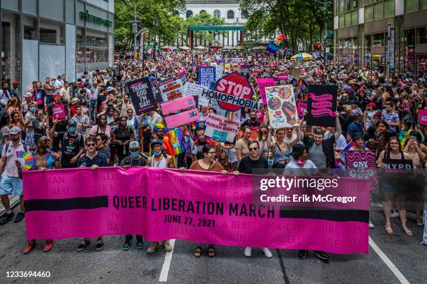 Participants seen marching behind a banner. Thousands of New Yorkers took to the streets of Manhattan to participate on the Reclaim Pride Coalition's...