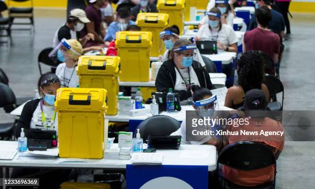 People receive the COVID-19 vaccine at a mass vaccination site in Toronto, Canada, on June 27, 2021. The City of Toronto hosted a one-day mass...