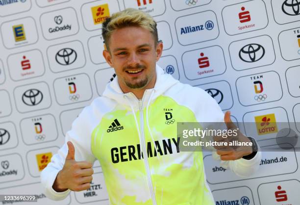 June 2021, Bavaria, Munich: Track and field athlete Yannick Wolf wears a new top while dressing part of the German Olympic team. Photo: Angelika...