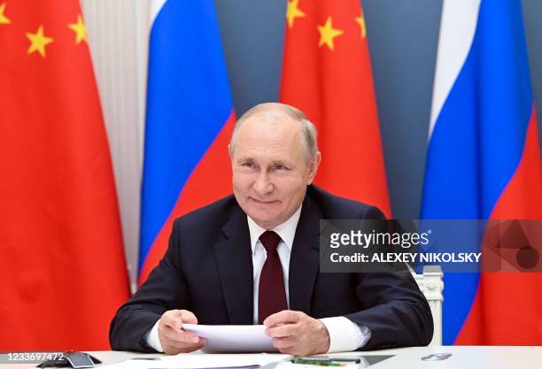 Russian President Vladimir Putin holds a meeting via video conference with Chinese President Xi Jinping at the Kremlin in Moscow on June 28, 2021.