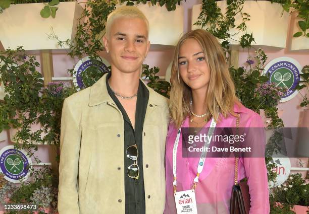 Romeo Beckham and Mia Regan pose in evian's VIP suite, certified as carbon neutral by The Carbon Trust, during day one of The Championships,...