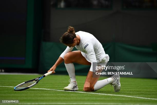 Romania's Monica Niculescu gets up after falling during play against Belarus' Aryna Sabalenka during their women's singles first round match of the...