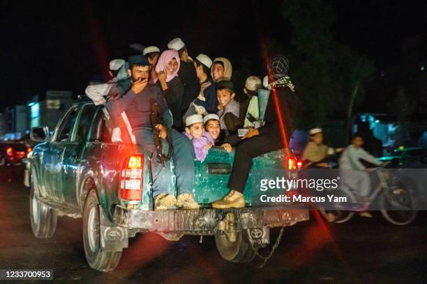 Children hitch a ride on the back of an Afghan Police vehicle in Kandahar, Afghanistan, Monday, May 3, 2021. The city of Kandahar, once the TalibanÕs...