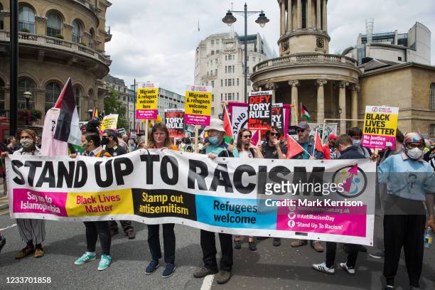 Supporters of Stand Up To Racism join thousands of people attending a United Against The Tories national demonstration organised by the People's...