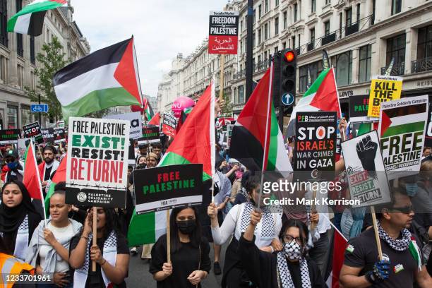 Pro-Palestinian activists join thousands of people attending a United Against The Tories national demonstration organised by the People's Assembly...