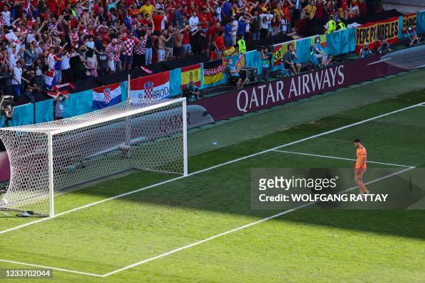 Spain's goalkeeper Unai Simon reacts after scoring an own goal during the UEFA EURO 2020 round of 16 football match between Croatia and Spain at the...