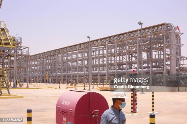 An employee at the Hawiyah Natural Gas Liquids Recovery Plant, operated by Saudi Aramco, in Hawiyah, Saudi Arabia, on Monday, June 28, 2021. The...