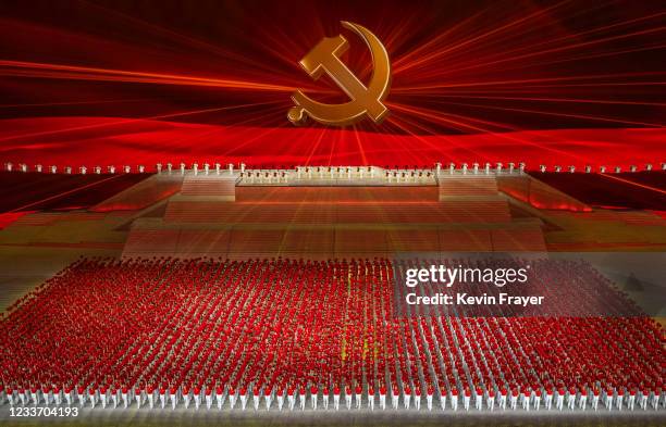 Large Communist Party logo is seen on a screen as performers gather during a mass gala marking the 100th anniversary of the Communist Party on June...