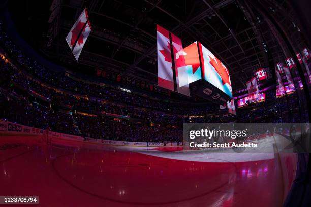 Amalie Arena is lit with the colors and flag of Canada during the Canadian National Anthem before the game between the Tampa Bay Lightning and the...