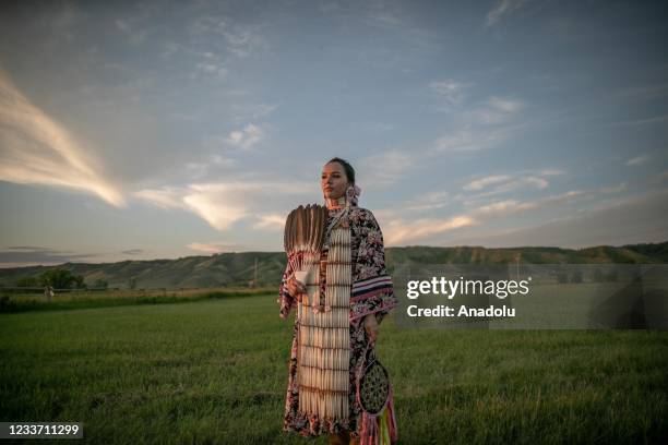 Jayda, from Cowessess first nation, poses in a traditional outfit during a ceremony to commemorate the victims of Cowessess first nation, in the...