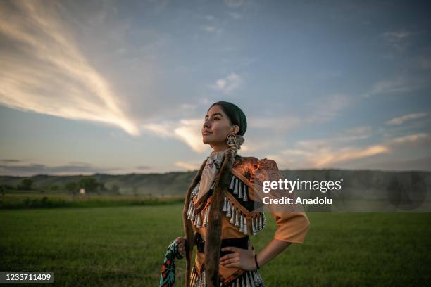 Girl from Cowessess first nation poses in a traditional outfit during a ceremony to commemorate the victims of Cowessess first nation, in the...