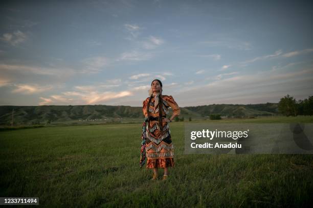 Girl from Cowessess first nation poses in a traditional outfit during a ceremony to commemorate the victims of Cowessess first nation, in the...