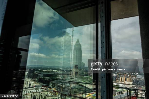 June 2021, Hessen, Frankfurt/Main: The Messeturm is reflected in a window of the "Eden Tower" in Frankfurt. According to the real estate developer, a...