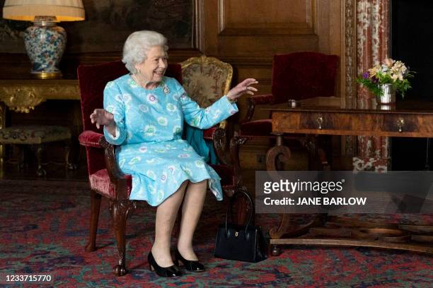Britain's Queen Elizabeth II smiles while speaking with Scotland's First Minister Nicola Sturgeon during an audience at the Palace of Holyroodhouse...
