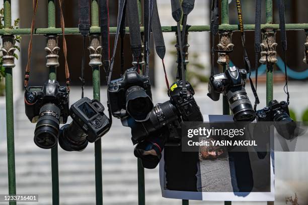 This photograph shows cameras and a picture of AFP photographer Bulent Kilic, hang in front of the Governor's Mansion in Istanbul, on June 29 during...