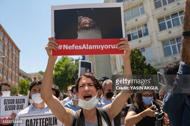 Protester holds an image of AFP photographer Bulent Kilic during a demonstration in front of the Governor's Mansion in Istanbul, on June 29 held to...