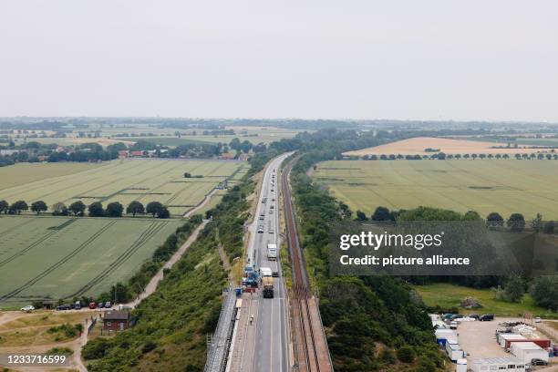 June 2021, Schleswig-Holstein, Fehmarn: Scaffolding is in place on the Fehmarnsund Bridge. Deutsche Bahn provided information on the status of...