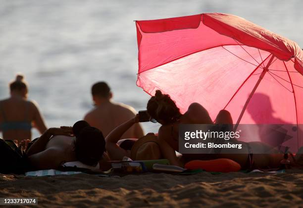 Beachgoers on English Bay Beach during a heatwave in Vancouver, British Columbia, Canada, on Monday, June 28, 2021. The heat is expected to continue...