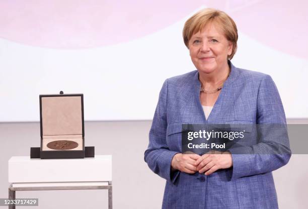 German Chancellor Angela Merkel smiles as she receives the Harnack Medal of the Max Planck Society at the Humboldt Carre on June 29, 2021 in Berlin,...