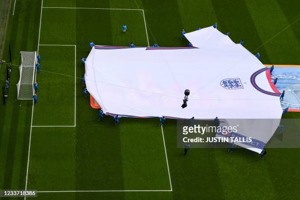 The England jersey is carried on the pitch ahead of the UEFA EURO 2020 round of 16 football match between England and Germany at Wembley Stadium in...