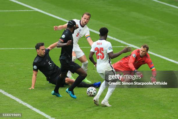 Mats Hummels, Antonio Rudiger and Germany goalkeeper Manuel Neuer put pressure on Harry Kane of England as he comes close, but the ball comes off the...