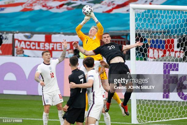 England's goalkeeper Jordan Pickford punches the ball clear during the UEFA EURO 2020 round of 16 football match between England and Germany at...